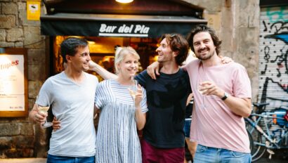 A group enjoys cava outside a tapas bar in Barcelona, Spain