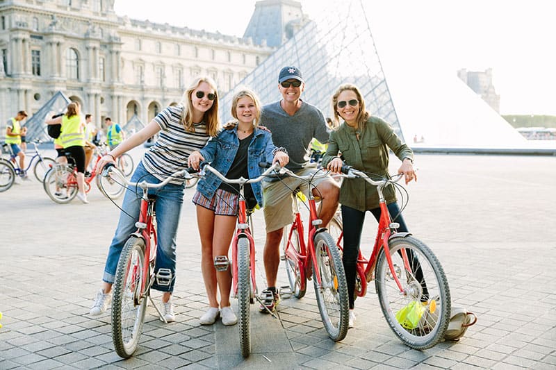 A family posed with their bikes at the Louvre in Paris, France