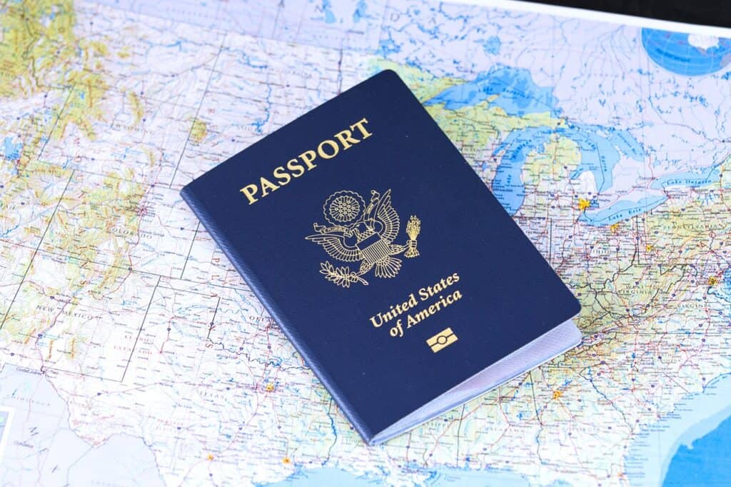 A U.S.A passport sitting on top of a map