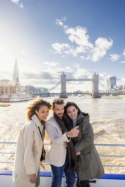 Friends take a selfie in front of the Tower Bridge in London